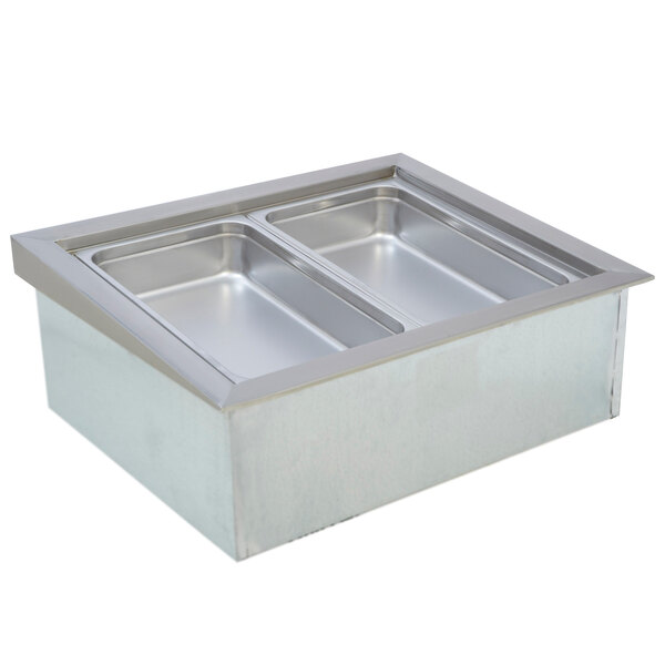 A Wells stainless steel drop in cold food well with a rectangular top over four pan inserts.
