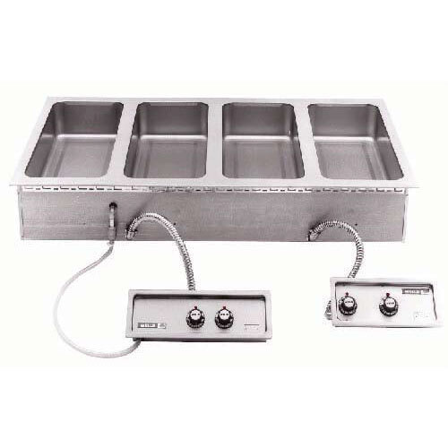 A Wells drop-in hot food well with four stainless steel pans.