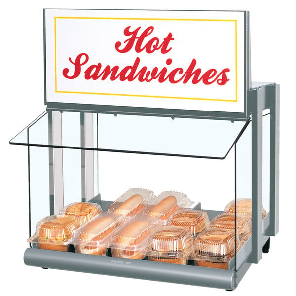 A Hatco countertop hot food display warmer with hot sandwiches in it.
