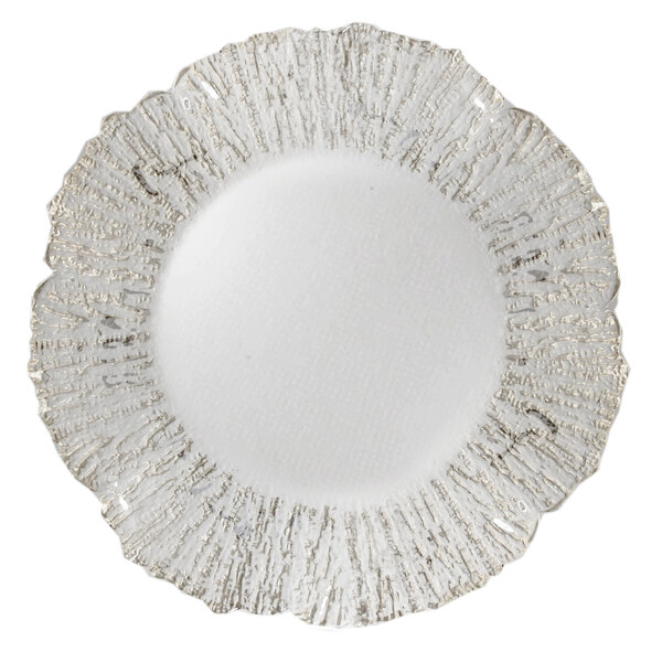 A white glass charger plate with a silver flower pattern.