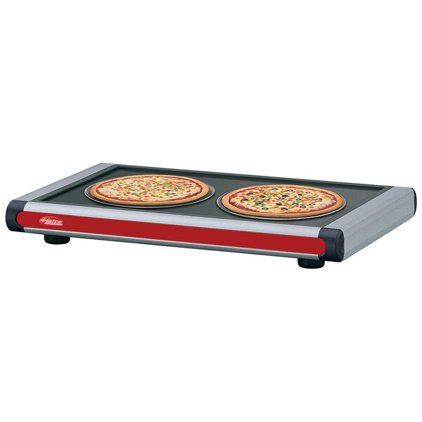 Hatco Glo-Ray heated shelves with black caps holding a pizza pan with two pizzas on it.