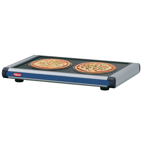 A navy blue Hatco heated shelf with black caps holding two pizzas.