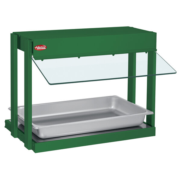 A Hatco Hunter Green Mini-Merchandising Warmer with a glass top over a metal tray.