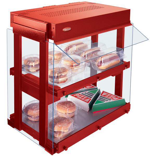 A red Hatco countertop food warmer with hamburgers and hot dogs in plastic containers.