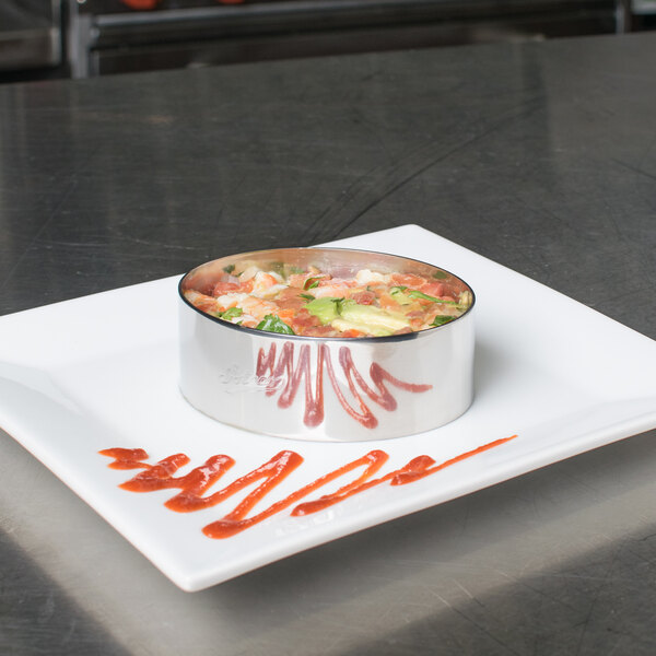 A plate with food made using an Ateco stainless steel oval mold.