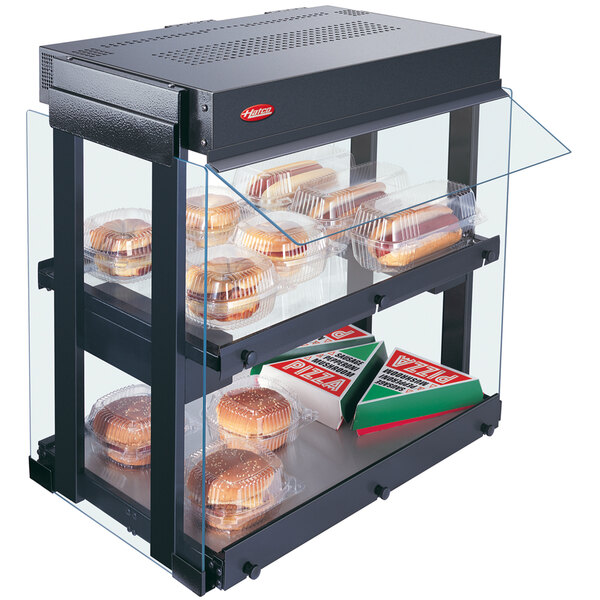 A Hatco countertop food warmer with heated glass shelves displaying food.