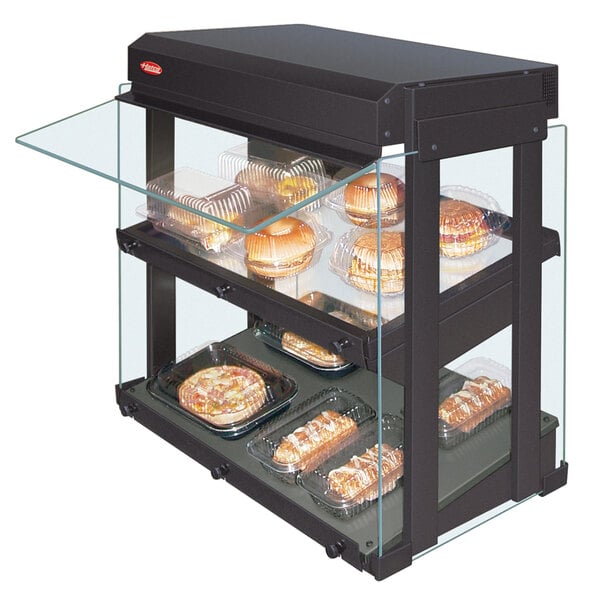 A Hatco countertop heated glass display case with food on slanted shelves.