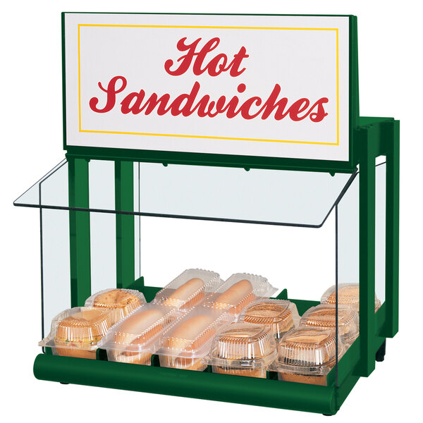 A Hatco countertop warmer with hot dogs and buns displayed inside.