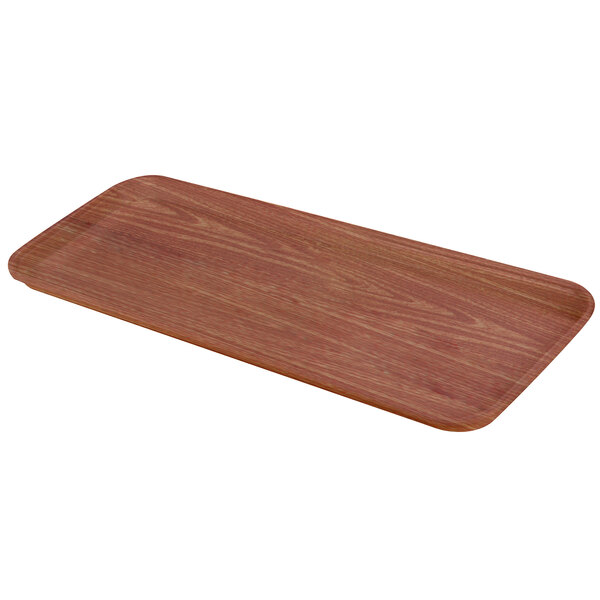 A rectangular Carlisle Glasteel tray with a wood grain finish.