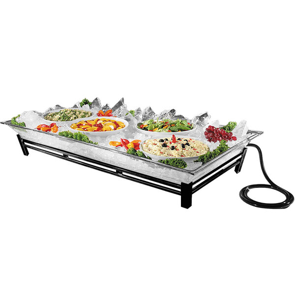 A large outdoor buffet with a Cal-Mil black ice housing system filled with food.