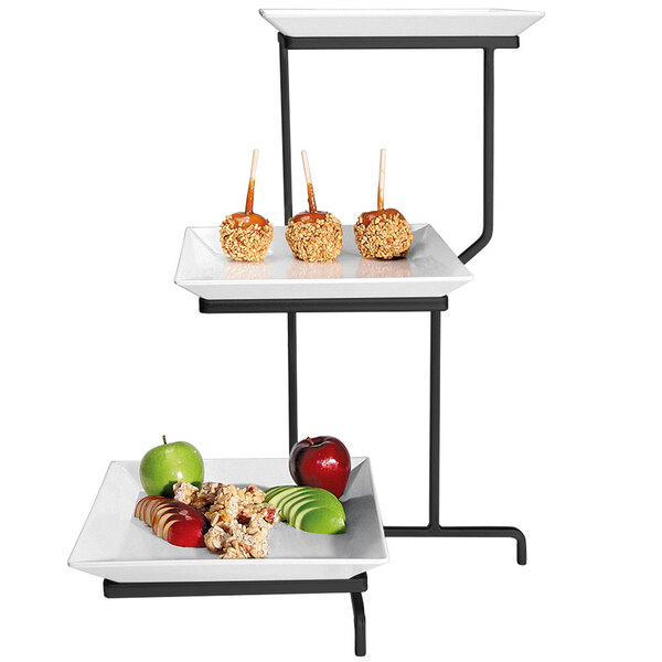 A three tiered Cal-Mil display stand with square porcelain plates of apples.