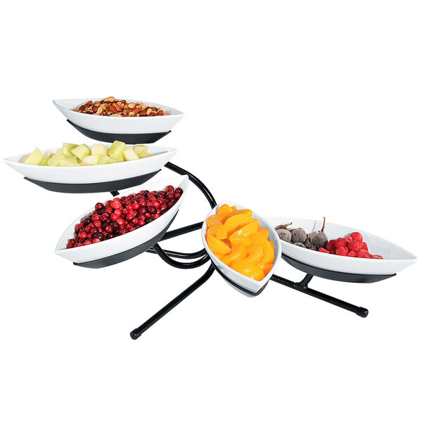 A black Cal-Mil tier stand with five canoe bowls of fruit on display.