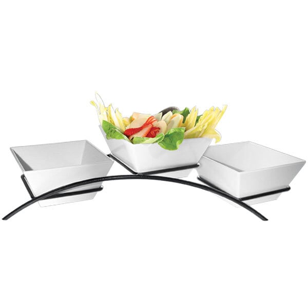 A black metal Cal-Mil arch stand with three square bowls of vegetables.