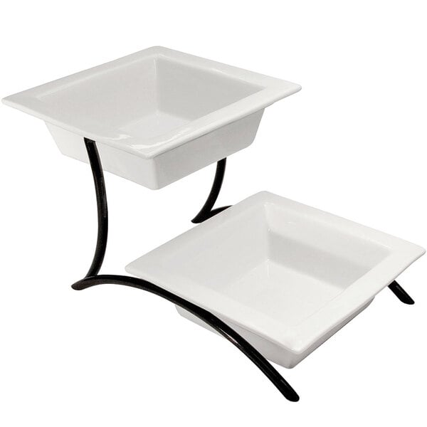 A black metal two tier display with white porcelain bowls on top.