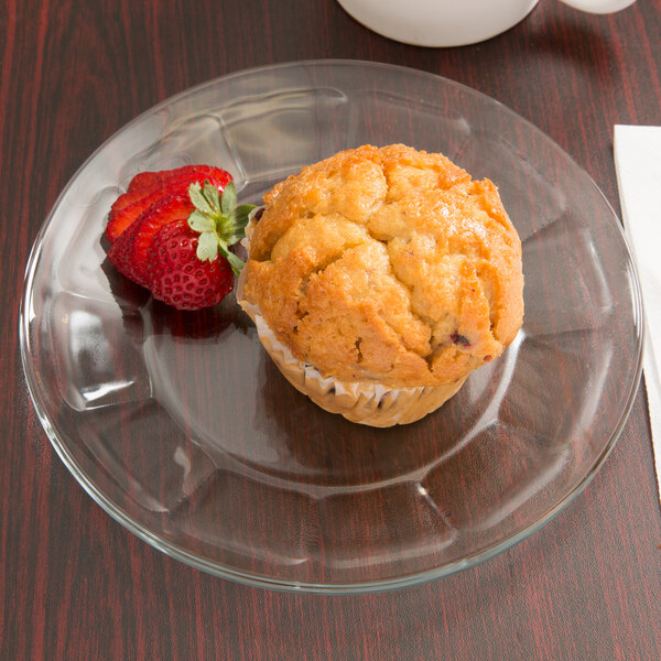 A Libbey Gibraltar glass salad/dessert plate with a muffin and strawberry on it.