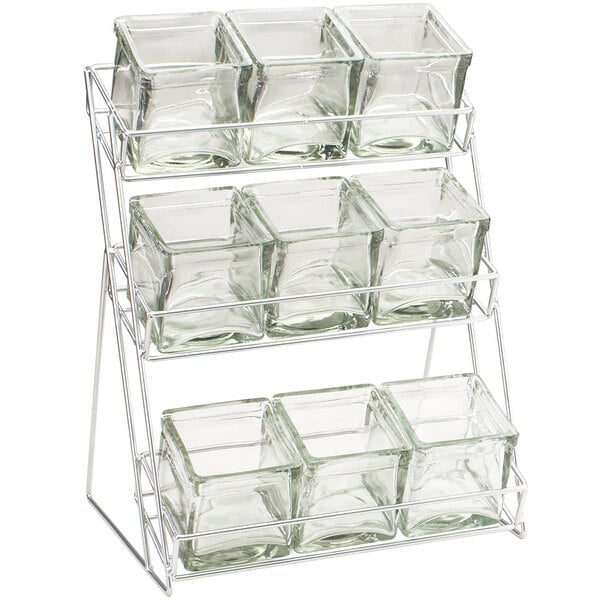 A Cal-Mil iron rack with glass containers on it.