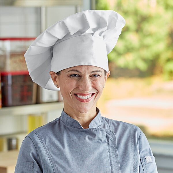 A woman wearing a white Choice chef hat.