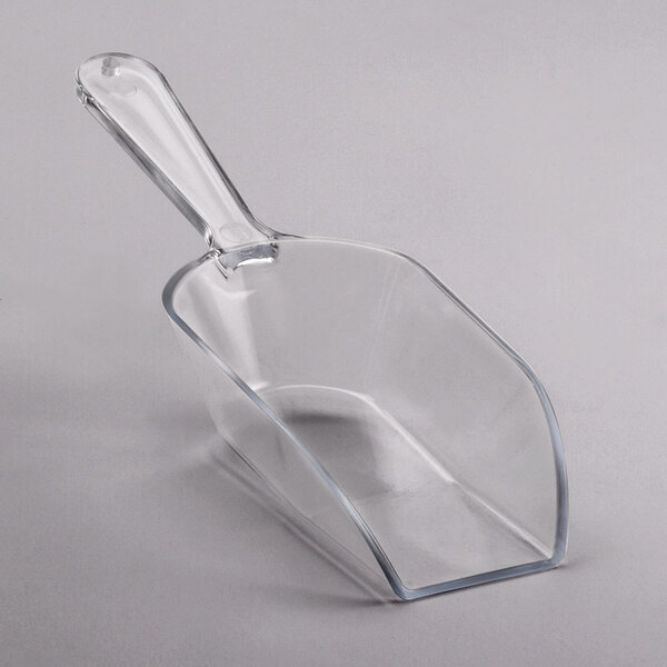A clear plastic scoop with a short handle.