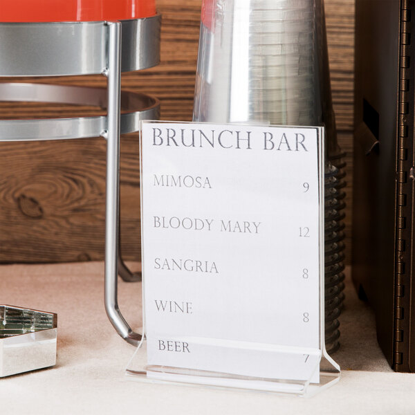 A Cal-Mil acrylic displayette with a brunch bar menu on a table.