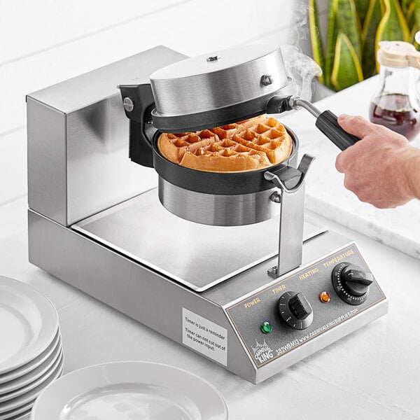 A person using a Carnival King Belgian Waffle Maker to make waffles.