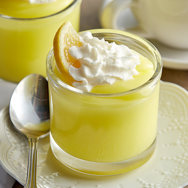 A glass of Cafe Classics lemon pudding with a lemon slice on top.