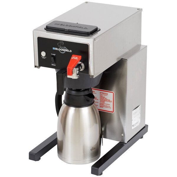 A Bloomfield automatic coffee brewer on a stand with a stainless steel thermal container.