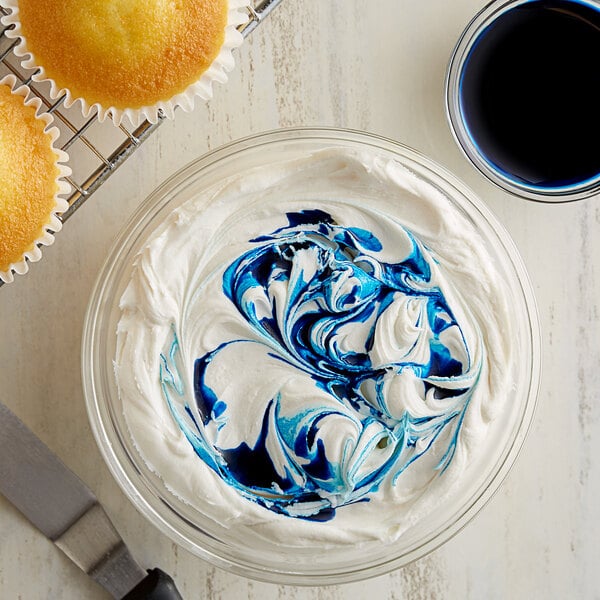 A bowl of frosting with blue and white swirls.