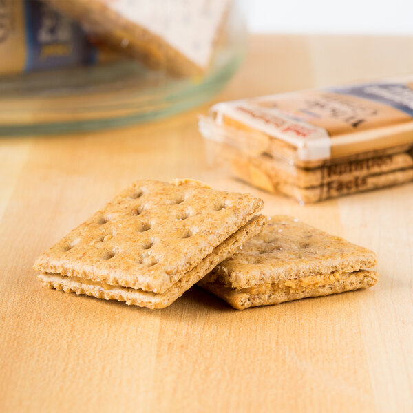 Two Lance Whole Grain peanut butter sandwich crackers on a table.