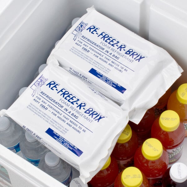 A white Polar Tech container filled with yellow-capped Re-Freez-R-Brix freeze packs.
