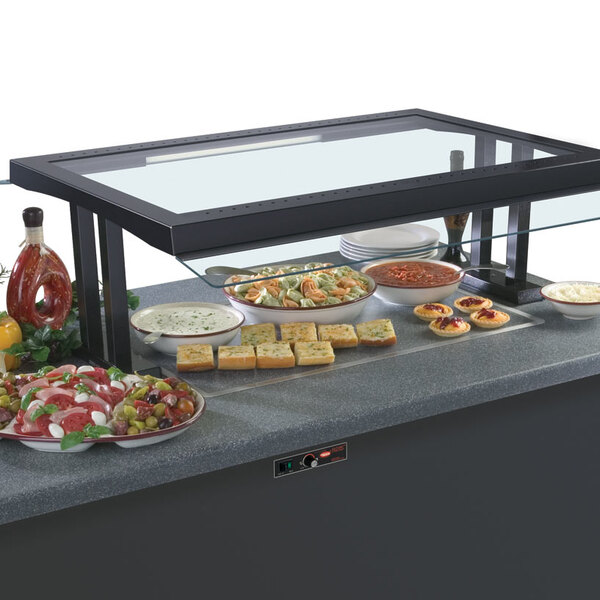 A Hatco Glo-Ray heated stone shelf with food on a counter.