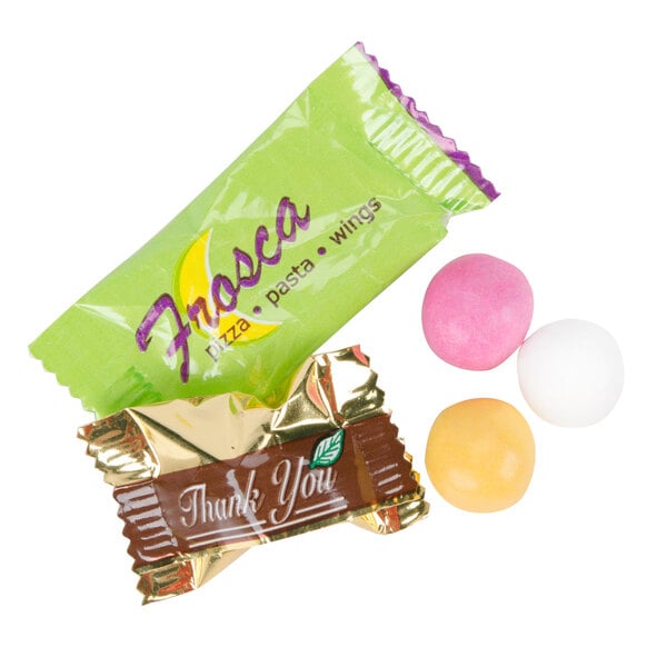 A green package of chocolate pastels with yellow and purple candy wrappers.