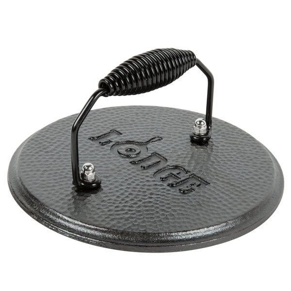 A Lodge pre-seasoned cast iron grill press with a handle.