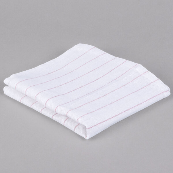 A folded white towel with red stripes.