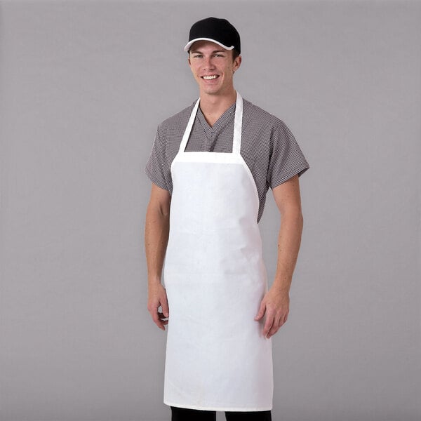 A man wearing a white Chef Revival bib apron.