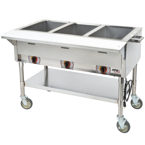 An APW Wyott stainless steel sealed well steam table with three pans on a counter.