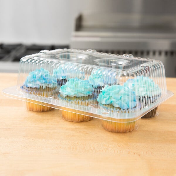 A Polar Pak plastic container with 6 cupcakes with blue frosting inside.