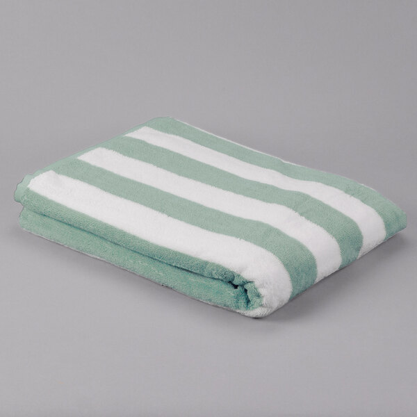 A folded Oxford cabana pool towel with white and green stripes.