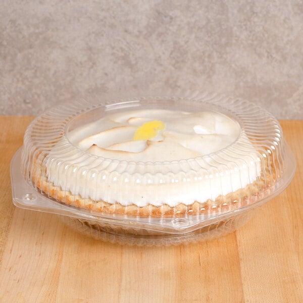 A close-up of a pie in a Polar Pak plastic container with a low dome lid.