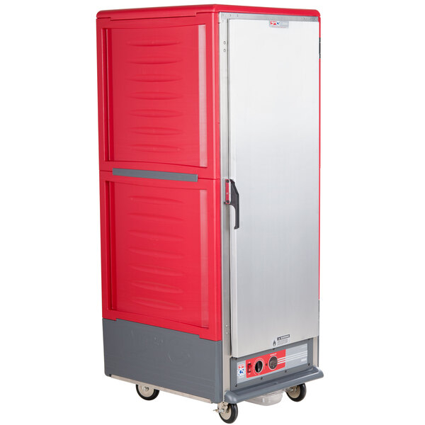 A red holding cabinet with a gray and silver handle on wheels.