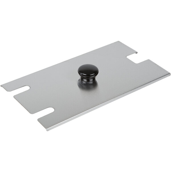 A metal plate with a black knob on it.