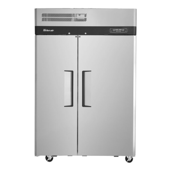 A silver Turbo Air refrigerator and freezer with black handles on two doors.