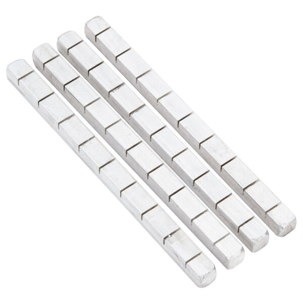 A row of four silver rectangular metal bars with white ends.