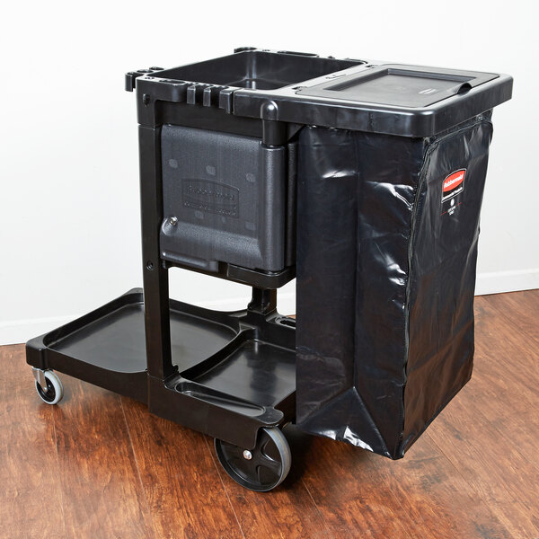A black Rubbermaid janitor cart with black bag inside.