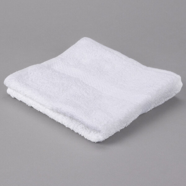 A white Oxford Regale hand towel with a dobby border on a gray surface.