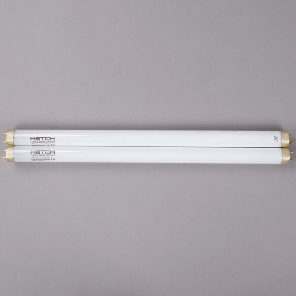 Two white rectangular Curtron UV fluorescent tubes.