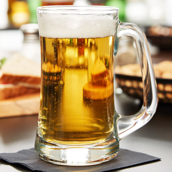 A Libbey Scandinavia beer mug filled with beer on a table.