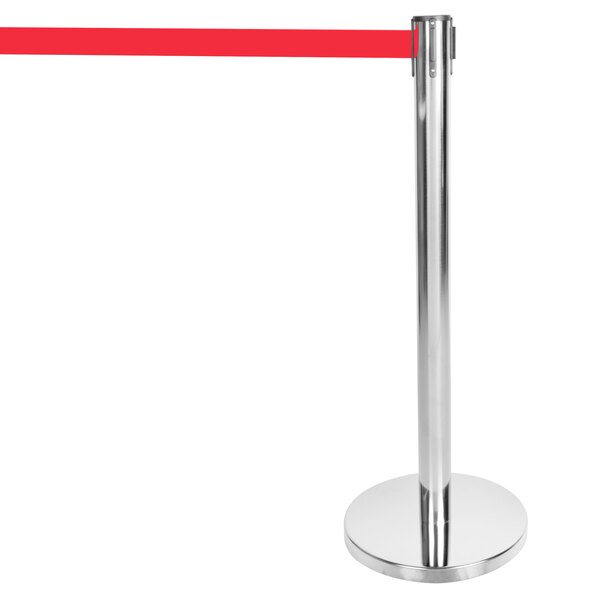 A silver metal Aarco crowd control stanchion with a red retractable belt.