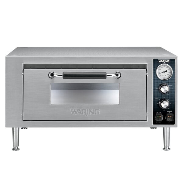 A stainless steel Waring countertop pizza oven with a glass door.