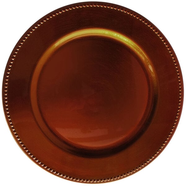 A brown plastic charger plate with a beaded copper rim.