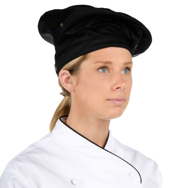 A woman wearing a black Chef Revival chef beret.